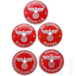 A collection of vehicle registration license plates