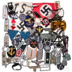A collection of insignia, armbands, equipment, spare parts, etc.