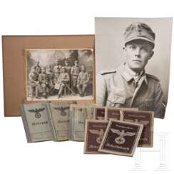 A collection of military passes, workbooks and two photos