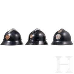 Three firefighters' helmets