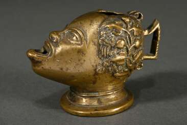 Bronze oil lamp ‘Head with open mouth’, in the sty…