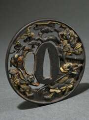 Oval openwork iron tsuba with gold inlaid ‘battle …