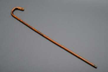 Bamboo walking stick with round handle and carved …