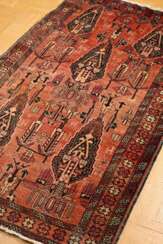 Persian garden carpet in reddish tones, five cypre…