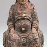 Skulptur "Sitzender Buddha", Holz geschnitzt, alte polychrome Fassung mit aufgesetzten Glasplättchen, rücks. ovale Aushöhlung, Gebrauchspuren, H. 45 cm - photo 1