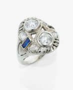 Bijoux de main. A ring with 2 old-European-cut diamonds and a sapphire