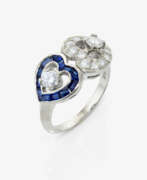 Bijoux de main. A ring with two hearts, sapphires, and brilliant-cut diamonds
