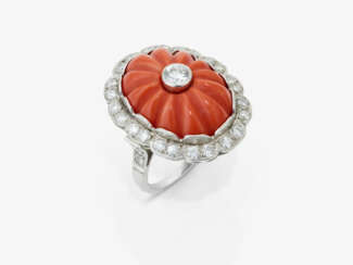 A striking historical cocktail ring adorned with a Midway coral and diamonds
