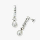 A pair of drop earrings with brilliant-cut diamonds and cultured pearls. A pair of stud earrings with diamonds - фото 2