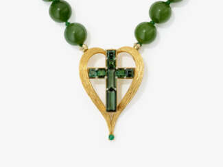 A vintage necklace with nephrite beads and a striking cross pendant, adorned with green tourmalines
