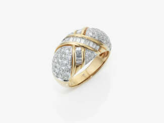 A modern cocktail-style band ring adorned with brilliant-cut and baguette-cut diamonds