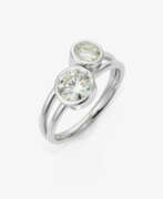 Украшения для рук. A modified cross over ring set with two brilliant-cut diamonds