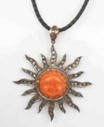 Product catalog. Gold pendant with diamonds and cut coral