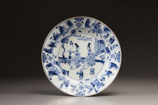 A blue and white plate - фото 1