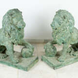 Pair of large bronze lions in sitting position with ball in paw on rectangular integrated bases - фото 1