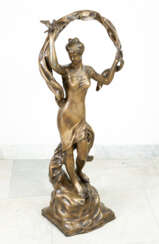 Large bronze sculpture of a gril with birds and scarf on naturalistic base