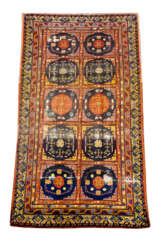Oriental carpet with ten field decoration bands and rich ornaments in blue red yellow brown and white colours signs of age and use