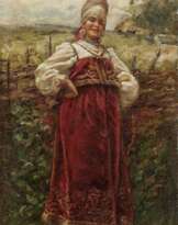 Junge Frau in Tracht vor dem Weidezaun