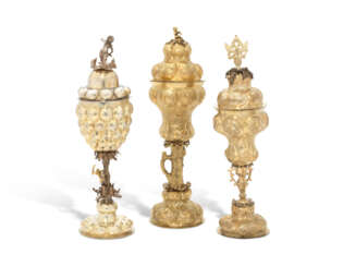 A PARCEL-GILT SILVER PINEAPPLE CUP AND COVER AND TWO SILVER-GILT CUPS AND COVERS