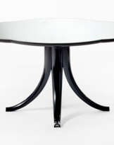 Coffee table with a four-lobed shape and hollow legs shaped like a saber