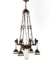 Small four-light wrought iron chandelier with pendant light bulbs supported by dog heads