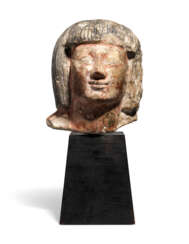 AN EGYPTIAN LIMESTONE HEAD OF AN OFFICIAL