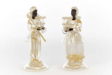 Two sculptures - candle holders depicting a man and a woman in eighteenth-century clothes