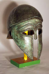 Corinthian bronze helmet in ancient style with open work eyes and nose protection, chased border lines and forehead deocrations