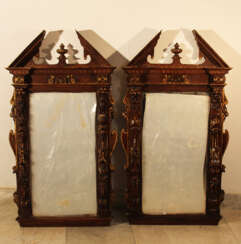 Pair of French mirrors in manieristic manner with roof top and rich figural and ornamental carvings on all sides, partly gilded