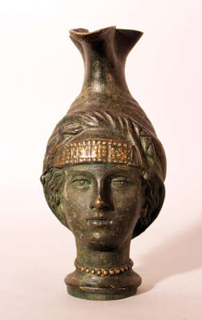 Bronze jug after the ancient, in shape of a female head with long neck as stand and bowed pressed spout - фото 1