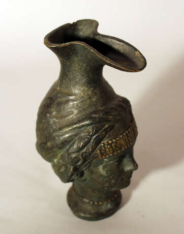 Bronze jug after the ancient, in shape of a female head with long neck as stand and bowed pressed spout - фото 3