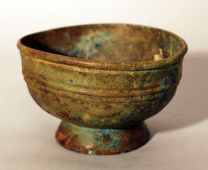 Chinese bronze bowl in archaic style, round shape with several deformations, on stand ring with fluted decorations