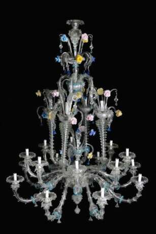 A large Venetian multicoloured and transparent 21 lights Murano glass chandelier with 16 S-shaped branches and spouts, 4 concave spiral columns ending in spouts and with turned connection to the upper central crown - photo 1