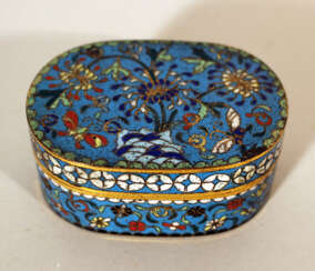 A small Chinese cloisonee oval box with lid, richly floral decorated in multicolours on blue ground, with white decoration band on the border