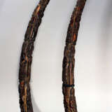 A pair of African horns with rich figural carvings on octagonal wooden bases - фото 1