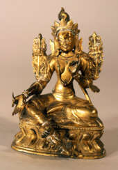 Bronze sculpture of Green Tara with crown, floral decorations on the sides and the hands and feet in blessing ceremonial position, one foot with earth contact
