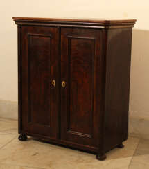 A small miniature armoire with two doors, round corners and on four feet