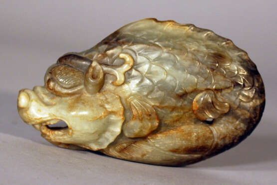 A Chinese jade dragon or fantasy beast, scuptured in green/grey jade with brown veins - photo 1