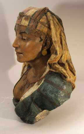A Goldscheider terracotta bust of an oriental lady, with cape, coins and waved dress - фото 2