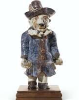 A CONTINENTAL POTTERY CISTERN IN THE FORM OF A HUNCHBACK