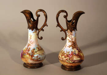 A pair of Vienna enamel jugs, each with bronze gilded mounts and hand grips