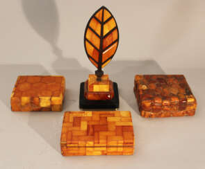 Lot of four amber objets including thee boxes with lids and one paper weight in shape of a feather on bronze base