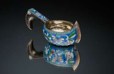 A bucket of silver with enamel.