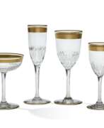 Wine glasses. A FRENCH GILT DECORATED CLEAR CUT GLASS STEMWARE SERVICE