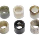 A GROUP OF SIX JADE AND HARDSTONE ARCHER'S RINGS - фото 3