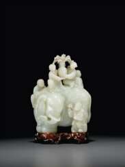 A LARGE AND FINELY CARVED WHITE JADE 'ELEPHANT AND BOYS' GRO...