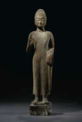A MAGNIFICENT LARGE GREY LIMESTONE STANDING FIGURE OF BUDDHA...