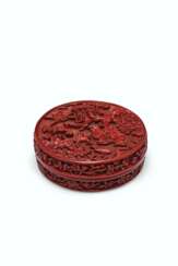 A RARE CARVED RED LACQUER CIRCULAR BOX AND COVER