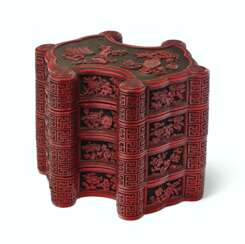 A CARVED RED AND BLACK LACQUER INGOT-FORM THREE-TIERED BOX A...