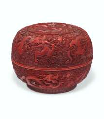 A CARVED CIRCULAR RED LACQUER 'NINE DRAGONS' BOX AND COVER